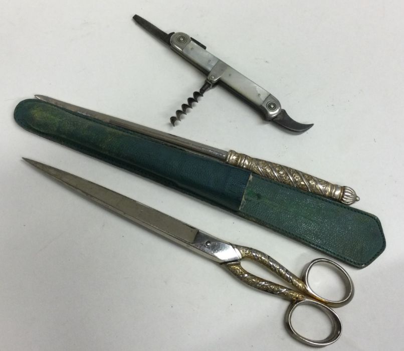 A pair of silver plated travelling scissors togeth