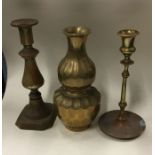 A group of three Antique brass candlesticks. Est.