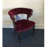 A Victorian button back upholstered chair on turne