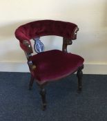 A Victorian button back upholstered chair on turne