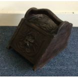 A carved oak coal purdonium. Est. £20 - £30.