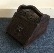 A carved oak coal purdonium. Est. £20 - £30.