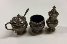 A heavy silver three piece cruet set of typical fo