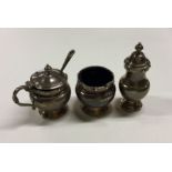 A heavy silver three piece cruet set of typical fo