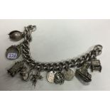 A large silver curb link charm bracelet with ring