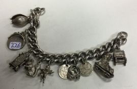 A large silver curb link charm bracelet with ring