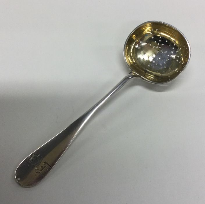 A Russian silver and silver gilt straining spoon w