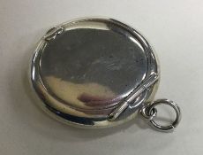 A plain silver miniature compact with hinged top.