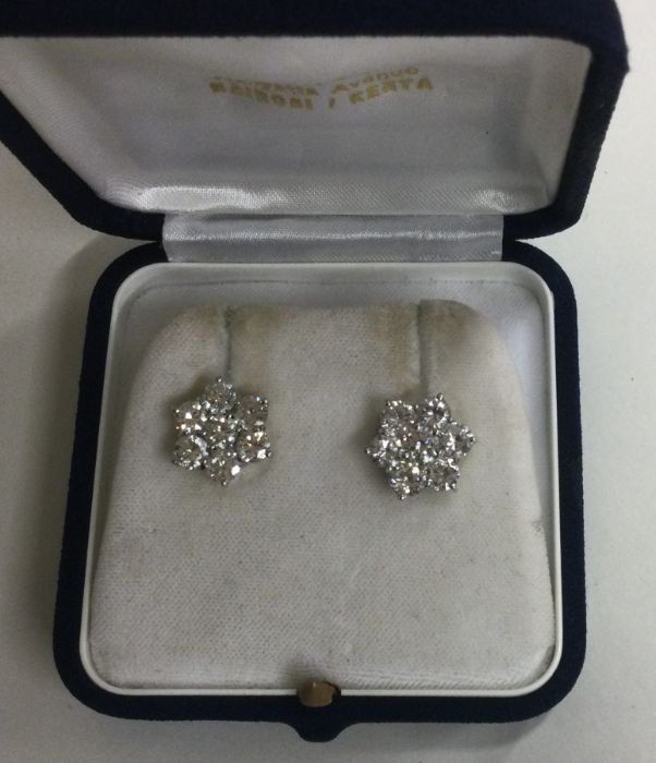 A good pair of large diamond circular seven stone