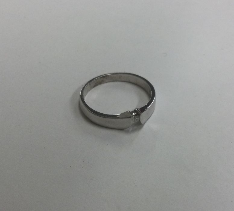 An unusual diamond single stone ring of plain form