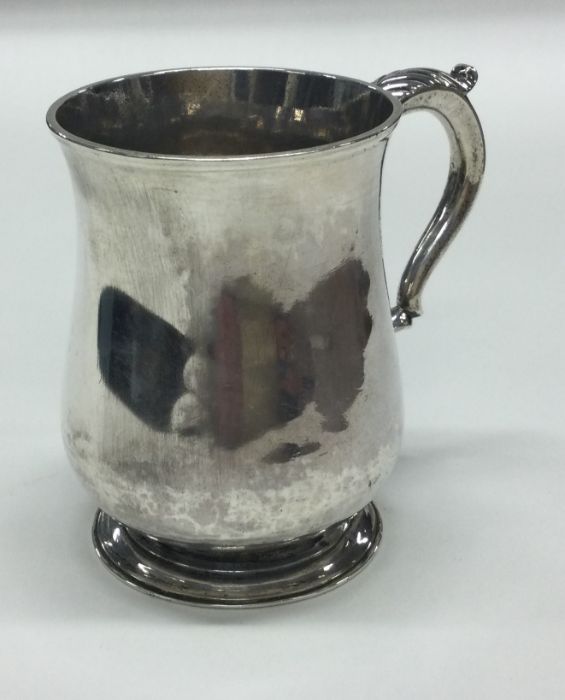 A good Georgian silver baluster shaped mug on swee