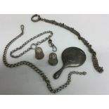 A collection of silver thimbles, chains, mirror et