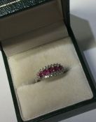 A ruby and diamond three row ring in 18 carat gold