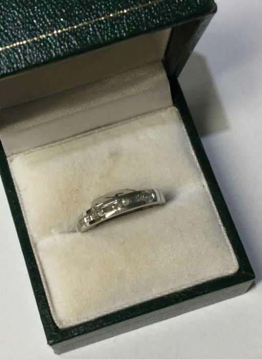 A 9 carat diamond half eternity ring of stylised f