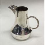 A heavy silver limited edition cream jug with text