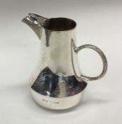 A heavy silver limited edition cream jug with text