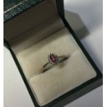 An oval diamond cluster ring in 9 carat setting. A