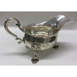 A good heavy George II silver sauce boat profusely
