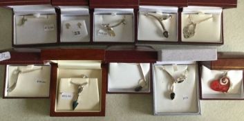 Ten cased silver pendants. Est. £25 - £30.