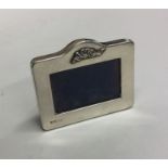 A small silver rectangular picture frame with bow