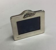 A small silver rectangular picture frame with bow