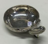AN 18th Century silver wine taster with scroll thu