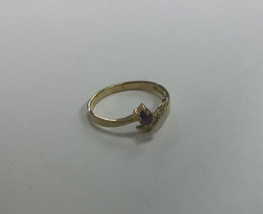 A ruby and diamond four stone crossover ring. Appr