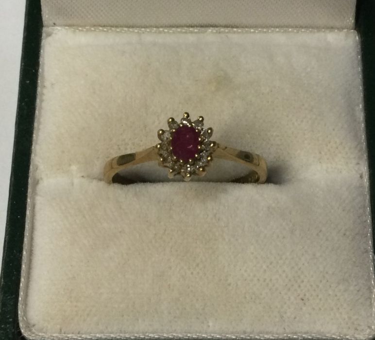 A 9 carat ruby and diamond cluster ring. Approx. 2 - Image 2 of 2