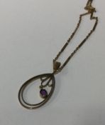 An amethyst pendant of oval form on 9 carat chain.