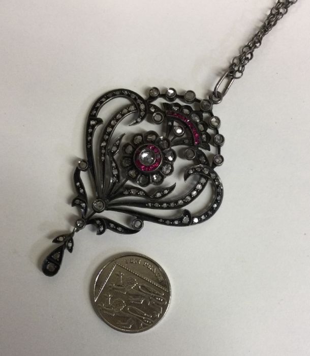 A large ruby and diamond drop pendant with scroll - Image 3 of 3