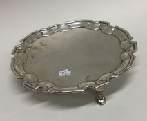 A George II circular silver waiter of shaped form.