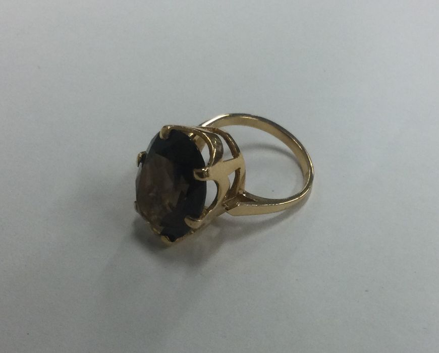 An 18 carat gold smoky quartz single stone ring i