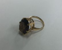 An 18 carat gold smoky quartz single stone ring i