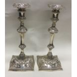 A good pair of heavy cast silver candlesticks with