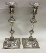 A good pair of heavy cast silver candlesticks with