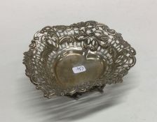 A small silver heart shaped bonbon dish decorated