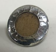 A small circular silver picture frame with easel m