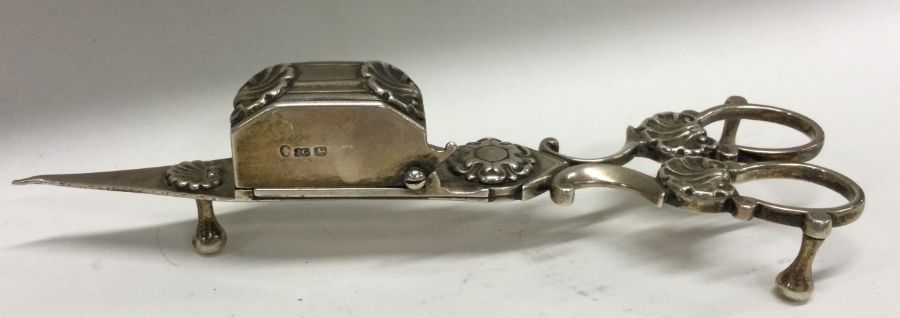 A good pair of Georgian silver candle snuffers wit