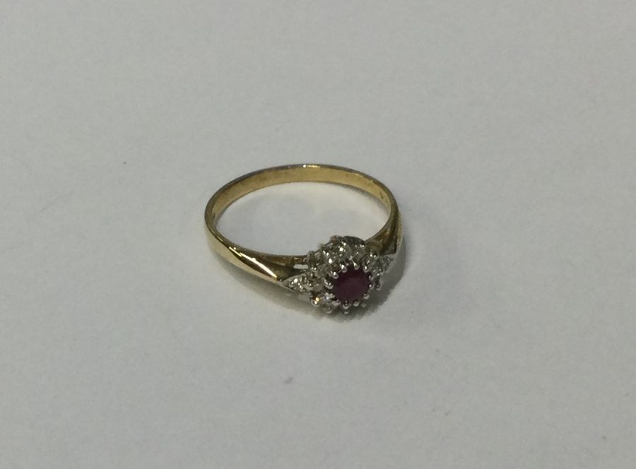 A 9 carat ruby and diamond daisy head cluster ring