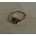 A small 9 carat ruby and diamond cluster ring in t