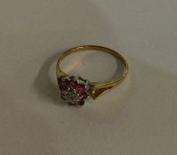 A small 9 carat ruby and diamond cluster ring in t