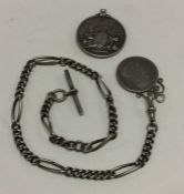 A silver curb link watch chain together with a Vic