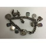 A heavy silver curb link charm bracelet decorated