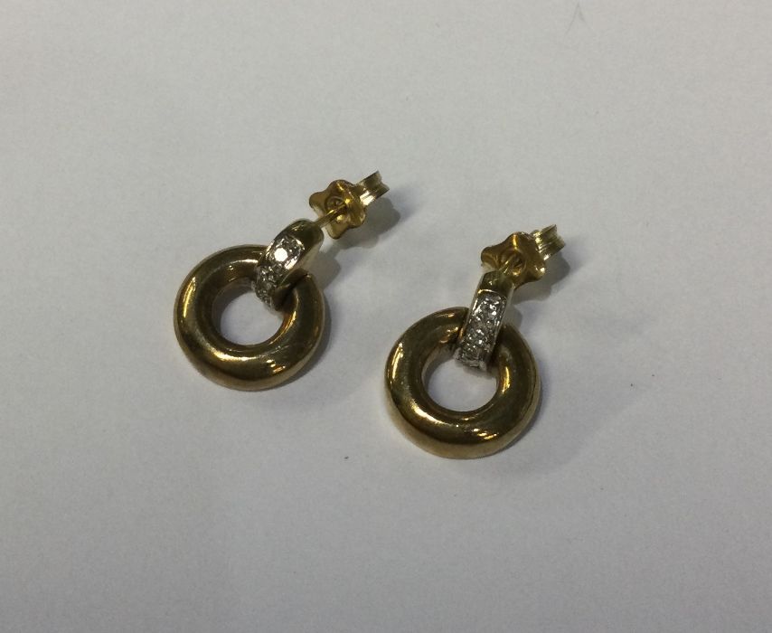 A pair of 9 carat hoop earrings with diamond inset