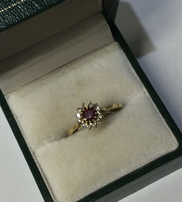 An 18 carat gold ruby and diamond cluster ring in