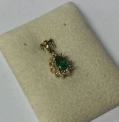 An emerald and diamond pendant of shaped form set