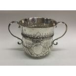 A good Queen Anne silver two handled porringer emb