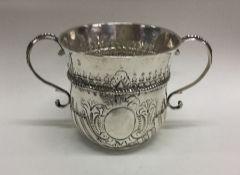 A good Queen Anne silver two handled porringer emb