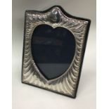 An Edwardian silver heart shaped picture frame of