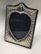 An Edwardian silver heart shaped picture frame of